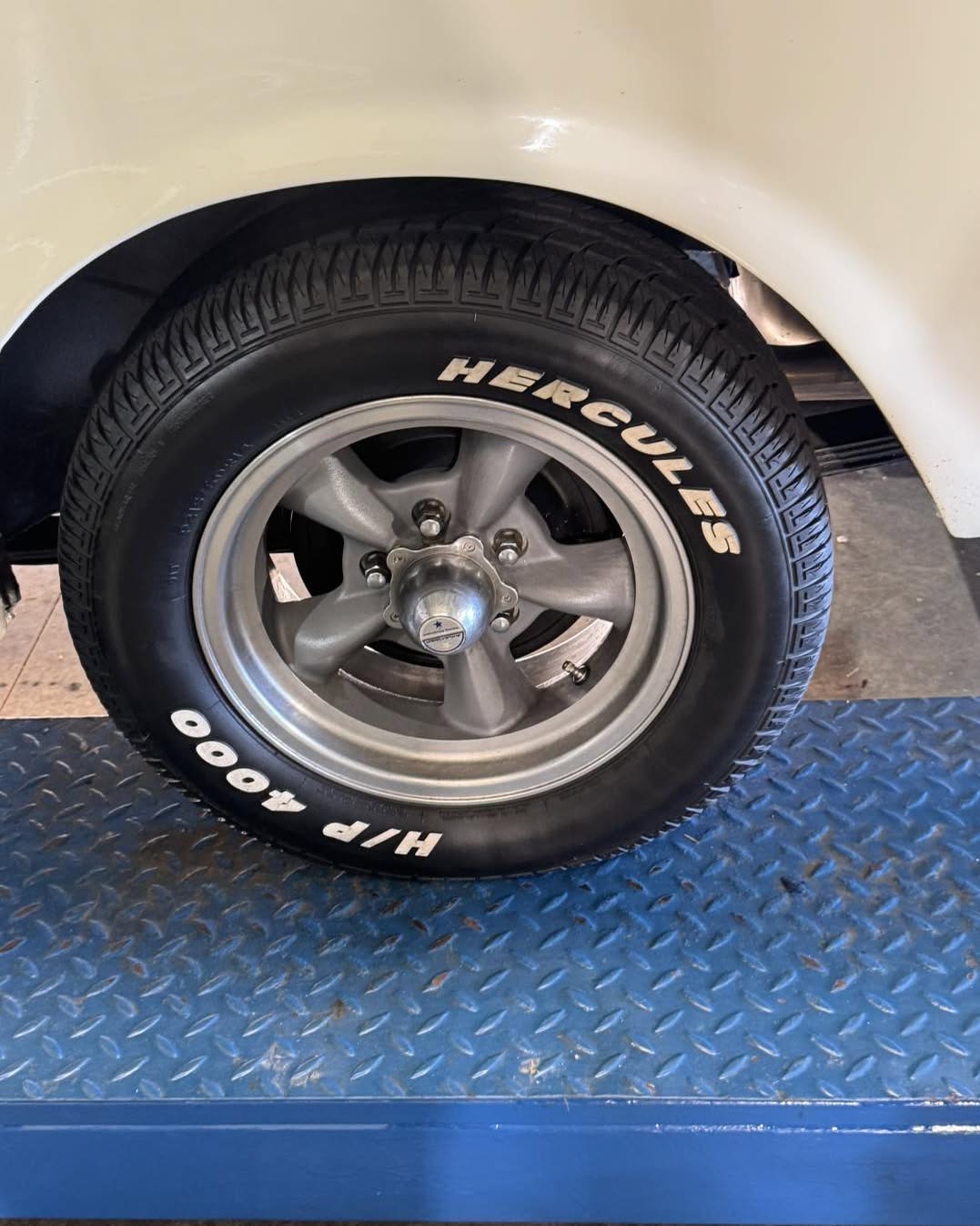 A Mustang wheel on the workshop ramp