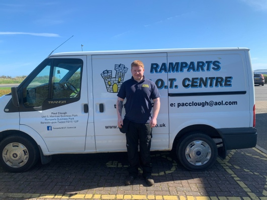 A member of the Ramparts team beside the liveried Ramparts M.O.T. Centre Transit van